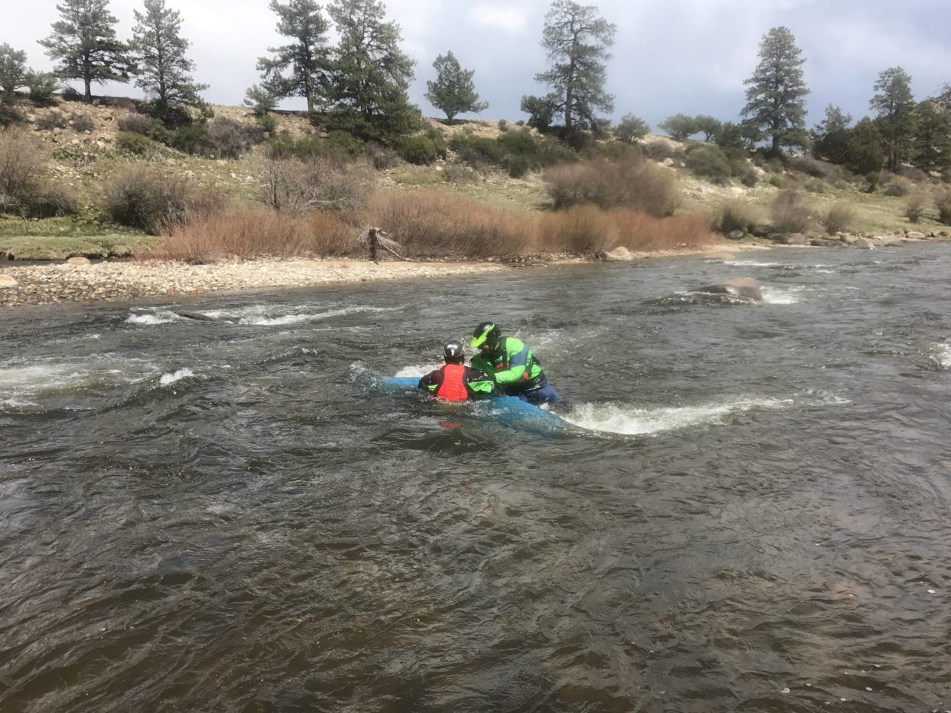 Flipping kayak over during swiftwater rescue training