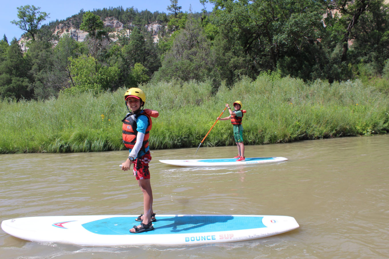 Kids on a paddle board trip during 3 day SUP trip