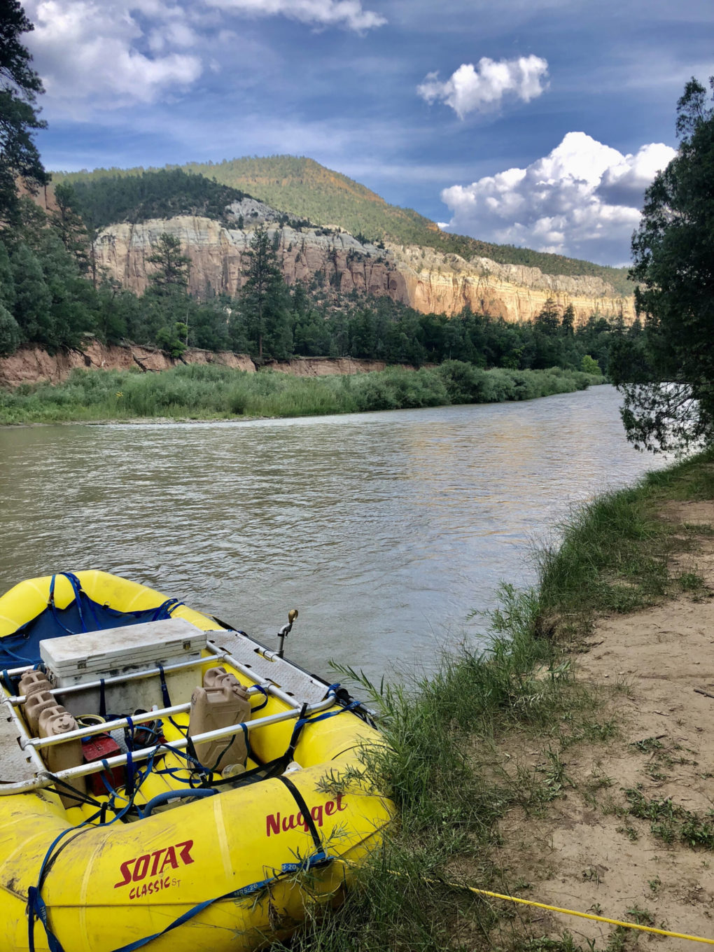 Pulling raft ashore on chama river rafting trip