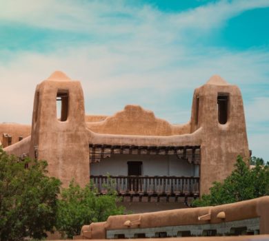 A blue sky and adobe building in Santa Fe after road trip from Las Vegas