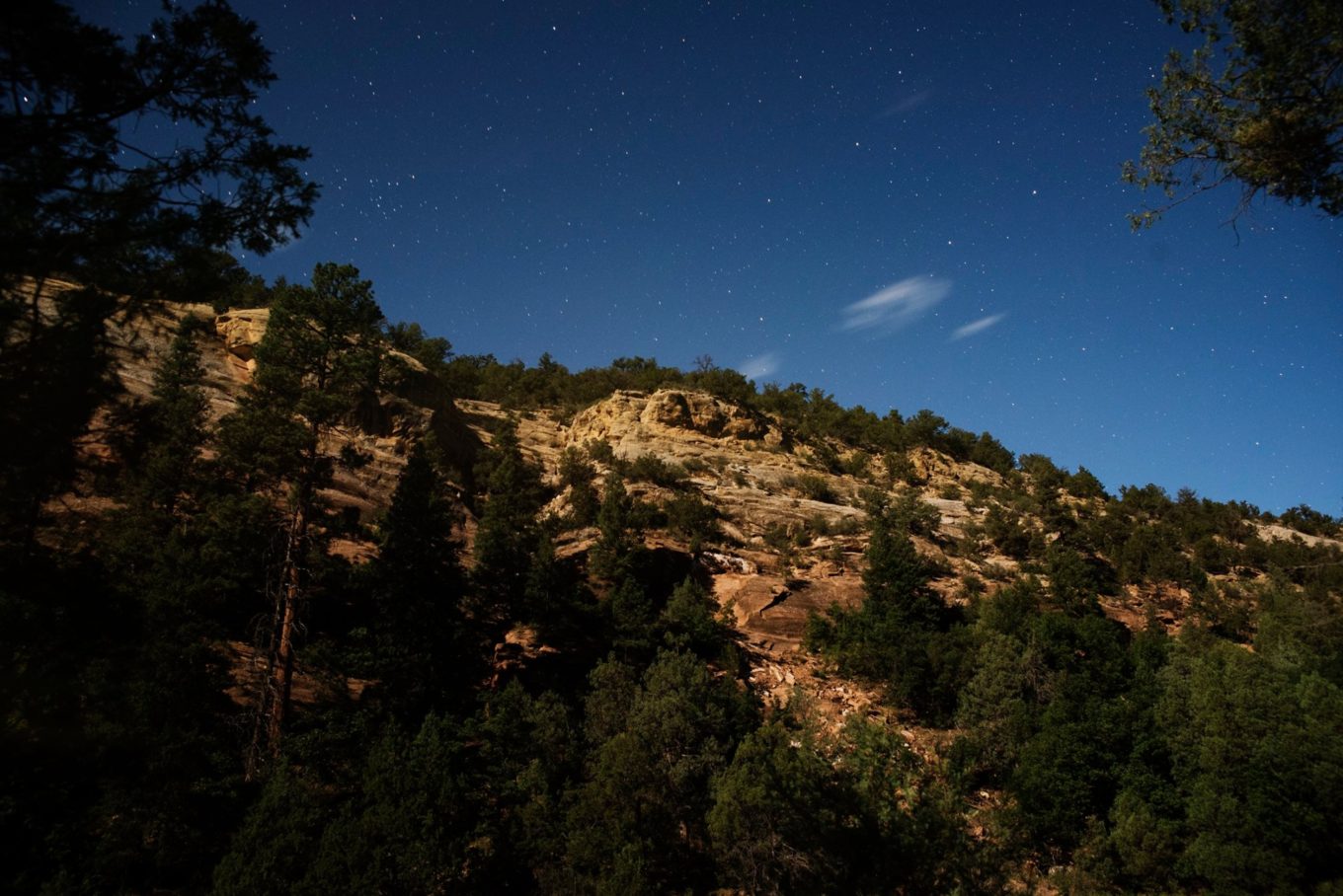 a blue starry and a rocky cliff